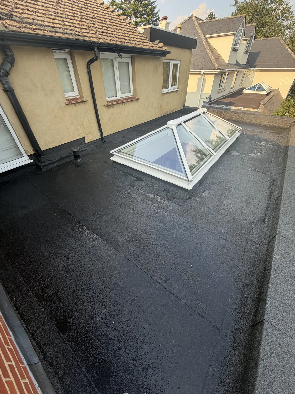 Completed three-layer felt warm roof in Cobham with new perimeter detailing