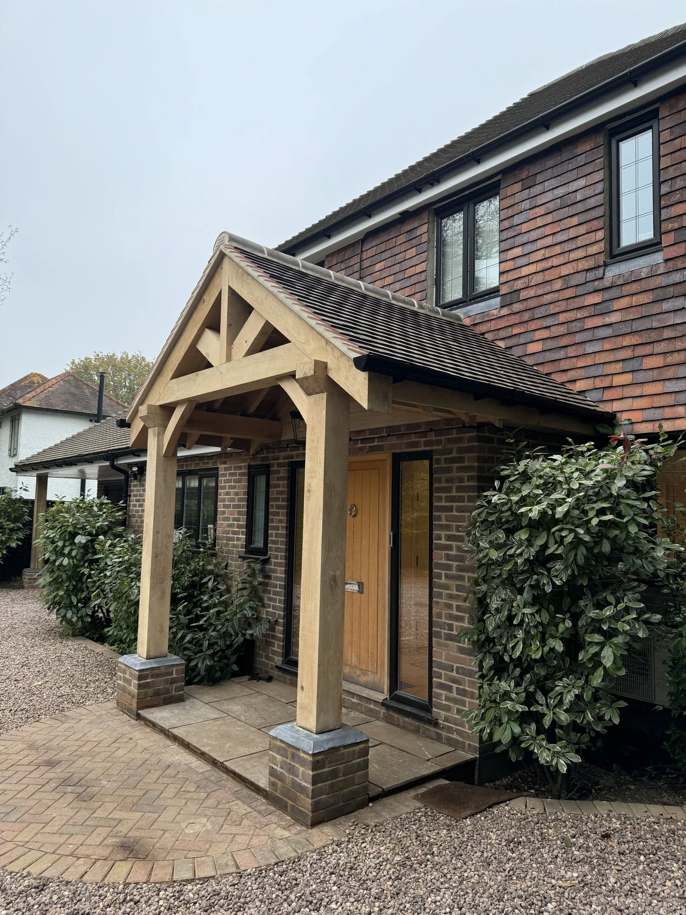 Finished oak porch and handmade clay tile roof in Fetcham