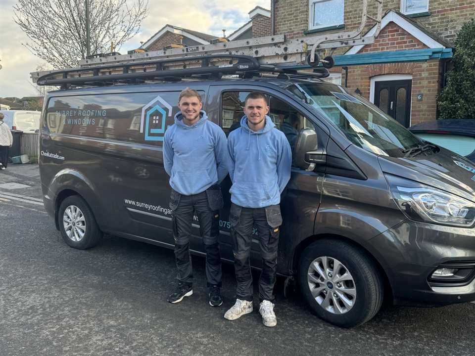 Max and Will from Surrey Roofing and Windows Ltd standing with the company van in Surrey