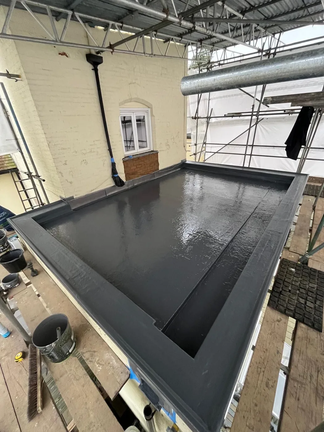 Completed dark grey GRP finish on the ventilated cold-deck flat roof in Redhill