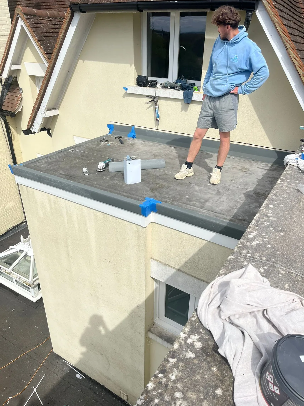 GRP laminate being applied to the smaller warm-deck flat roof in Redhill