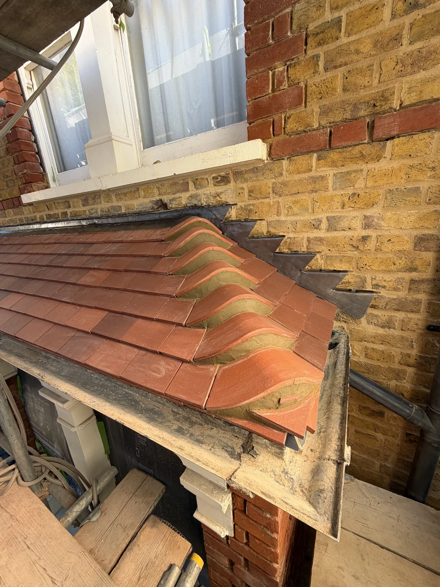 Code 4 lead flashing and rosemary clay tiles on a porch roof in Richmond