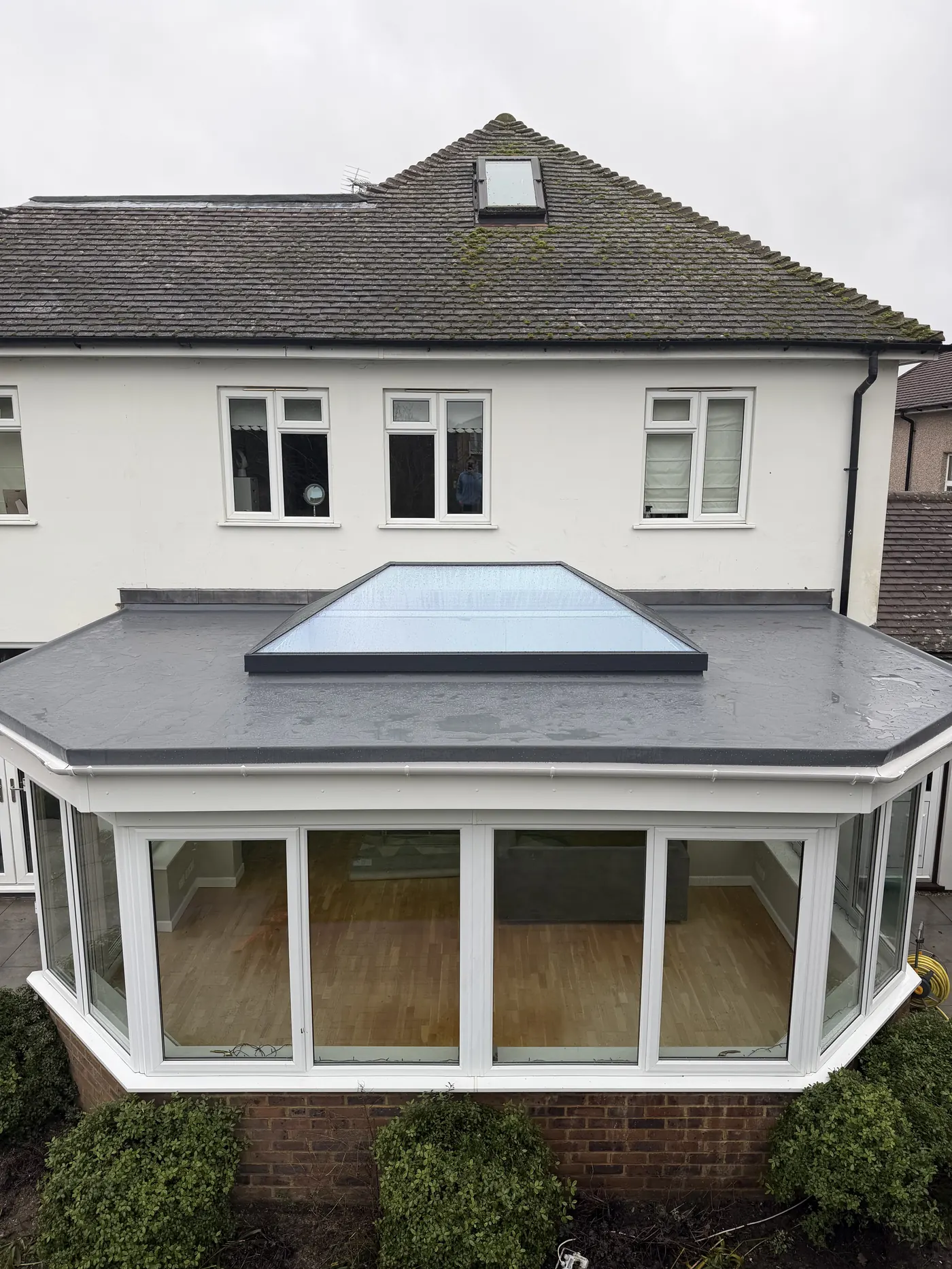 Completed Sunbury flat roof with grey Res-Tec waterproofing, white guttering and Duplus roof lantern