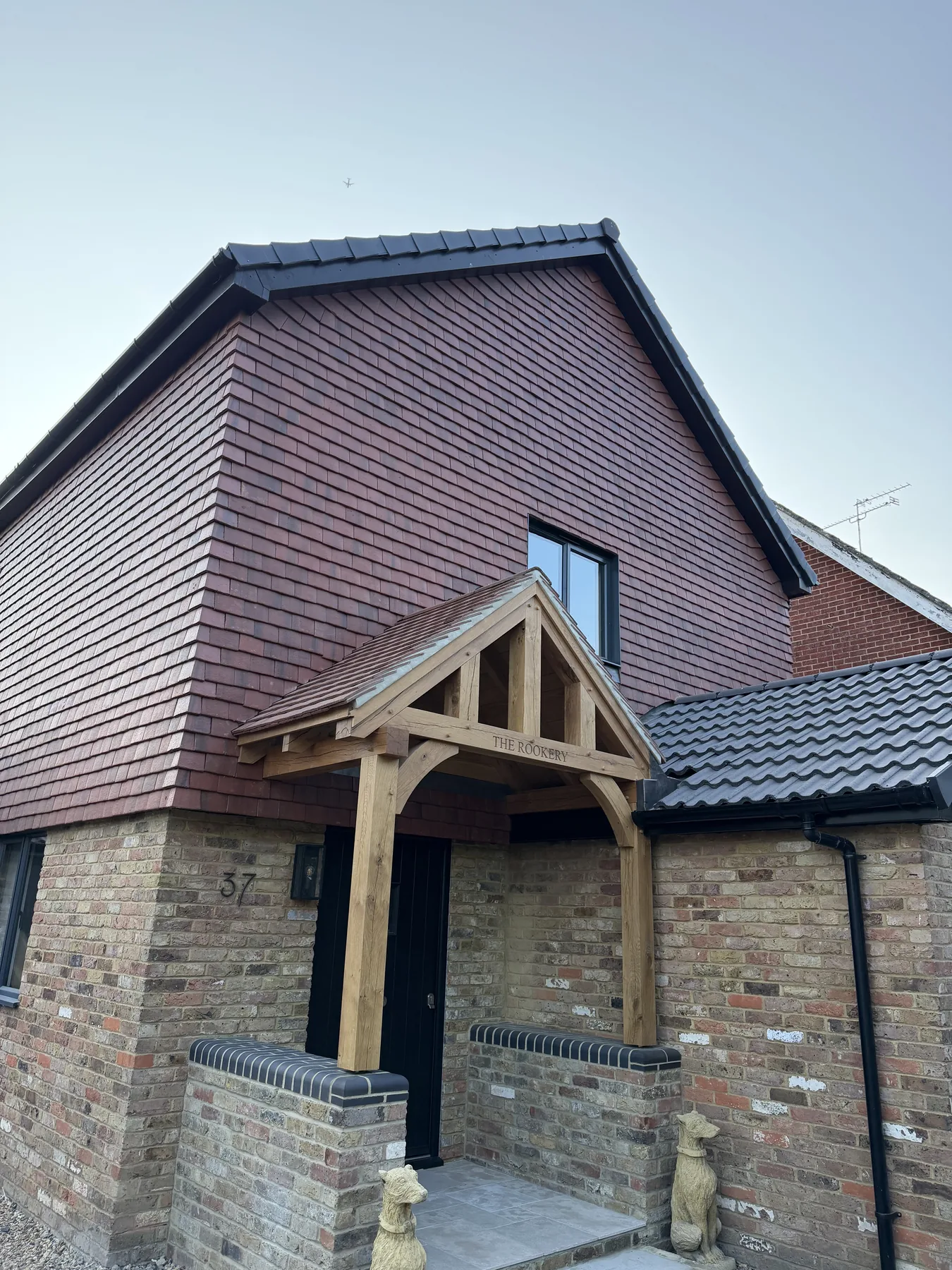 Bespoke oak porch tied into hanging tiles and adjoining roof in West End, Surrey