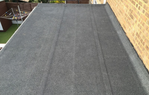 A high-performance mineral felt flat roof replacement for a Guildford property, showing a clean, waterproof surface.